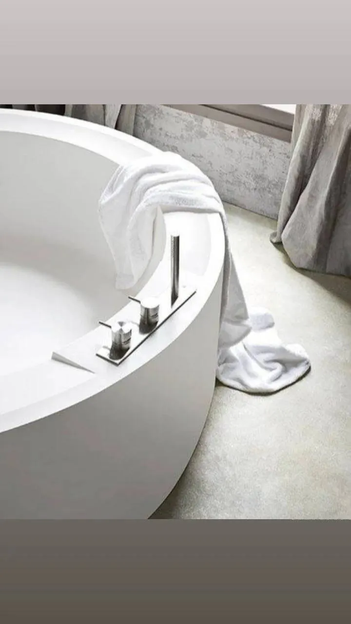 Bathroom renovation with freestanding bath and stone finishes.
