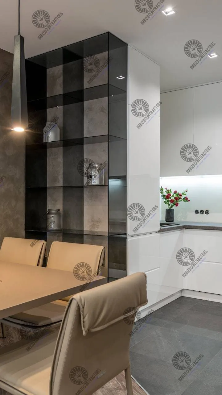 Grey and white kitchen renovation with dark shelving unit.