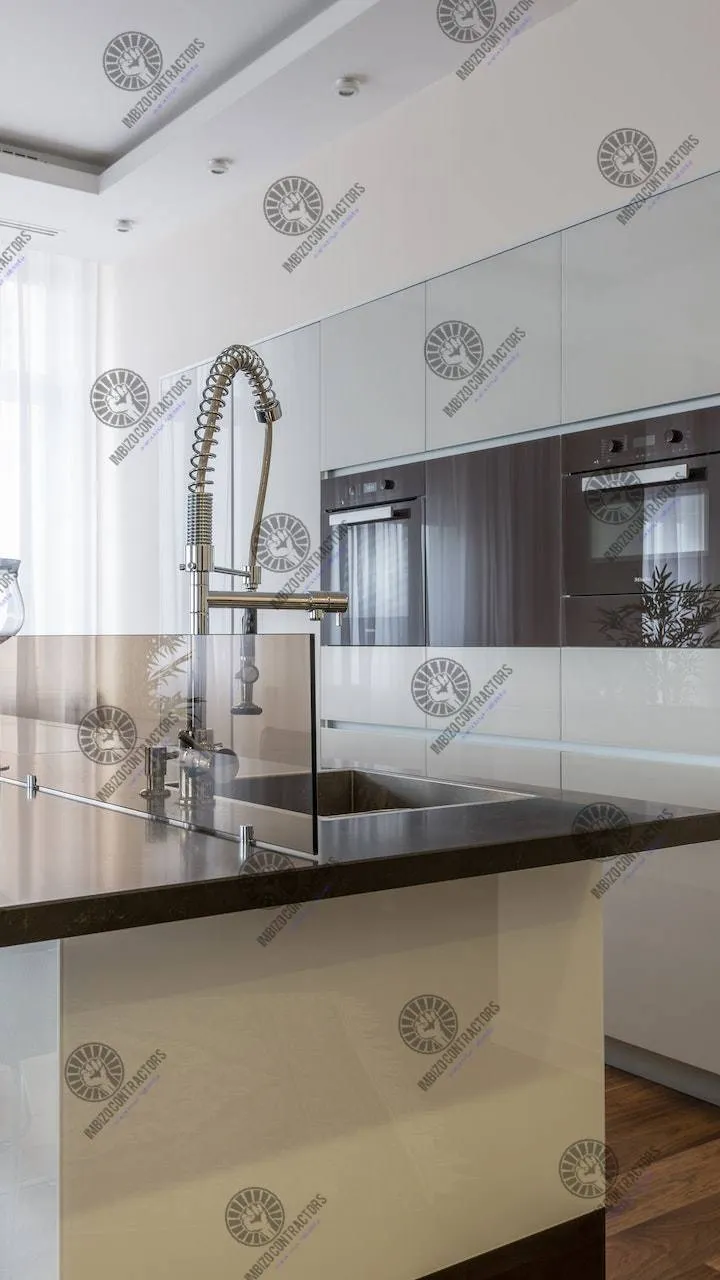 Finished kitchen with fitted appliances and island.